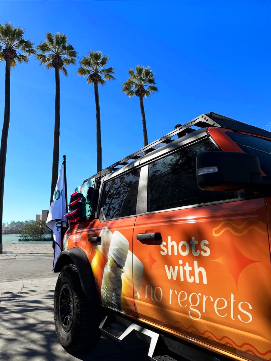 The wrapped Jamba Bronco under palm trees