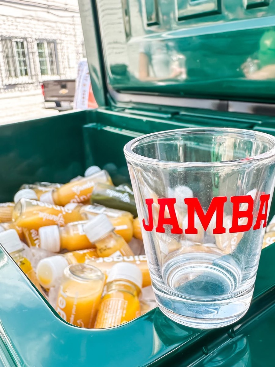 Jamba shots on ice beside a branded glass