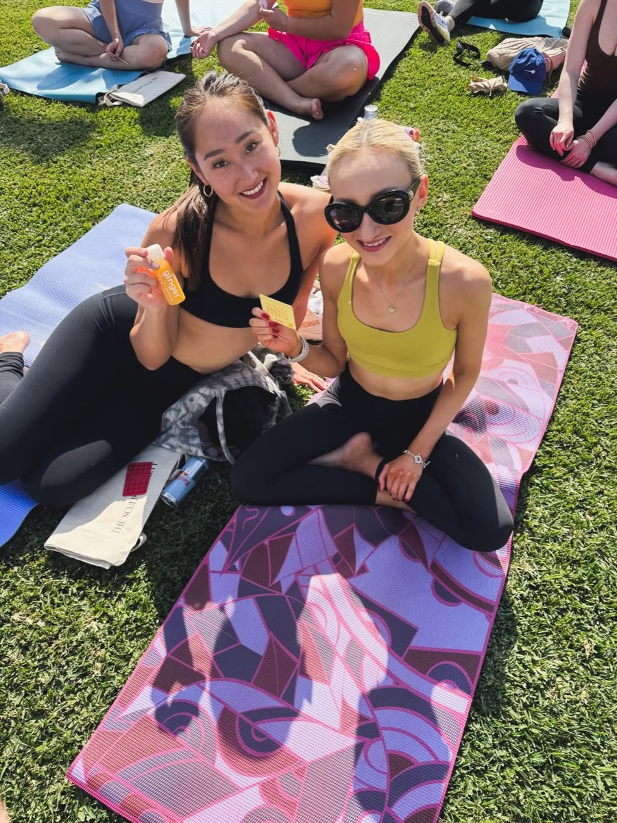 Two guests sitting on mats with Jamba shots