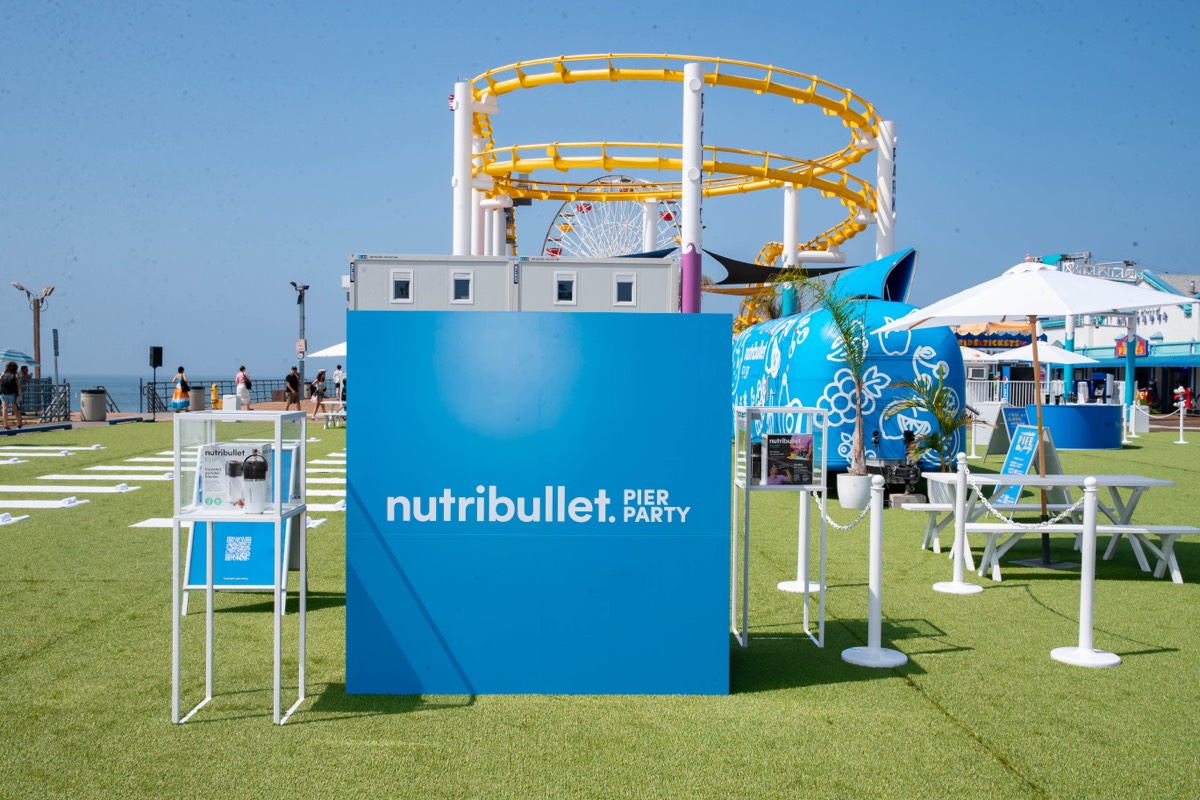 The NutriBullet Pier Party build with the Santa Monica rollercoaster behind it
