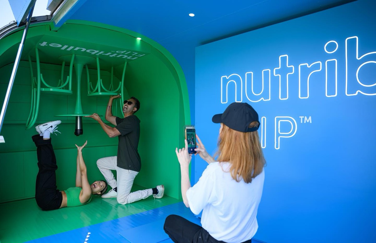 Guests lying on the floor posing under the upside-down café